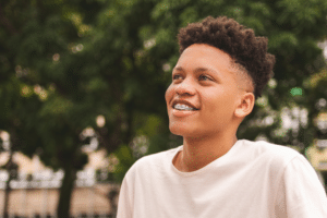 Smiling teenage boy wearing braces outdoors